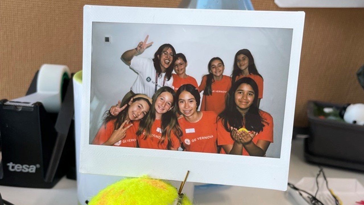 Polaroid of Paolo and 7 young girls in GE Vernova t shirts